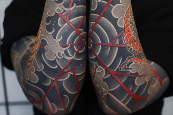 Japanese forearm tattoo with waves and red line details