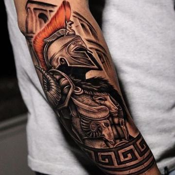 Spartan helmet tattoo with shield and red accent