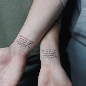 Matching text tattoos on both wrists