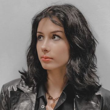 Three-quarter portrait of a person with a septum ring, wearing a black leather jacket, illustrating safe, professional facial piercing options in Klaipėda.