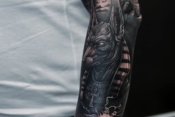Dark realistic sleeve tattoo on the arm