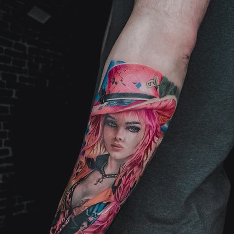 A vivid portrait tattoo on the forearm with bold red tones and graphic black details