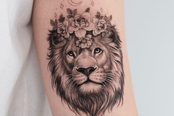 Lion tattoo with floral crown and soft shading