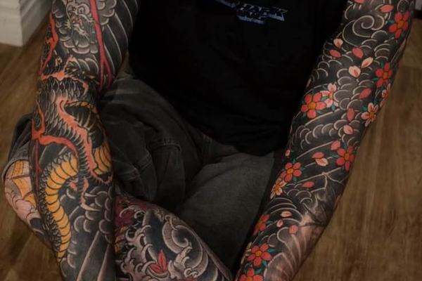 Japanese sleeve tattoo with dragon, clouds and red flowers
