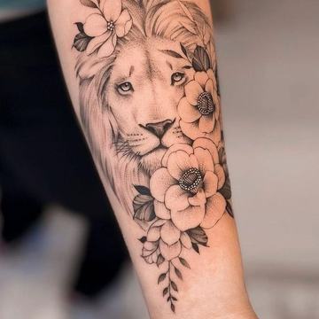Lion tattoo with flowers on forearm