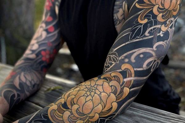 Close-up of Japanese sleeve tattoo with peony and waves