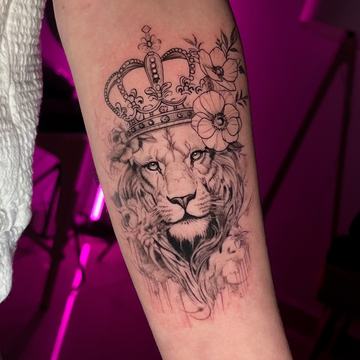 Lion tattoo with crown and floral details