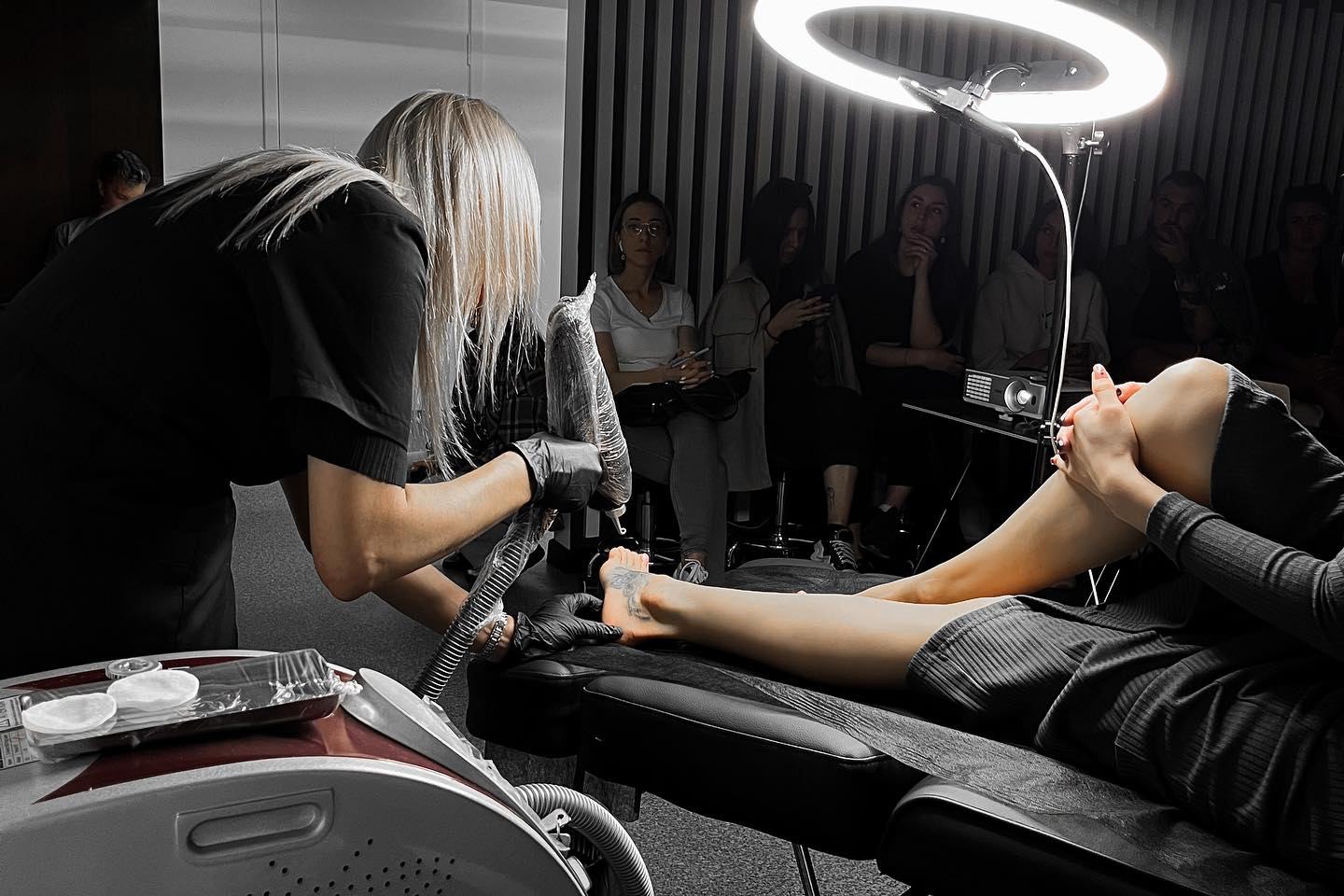 specialist performing tattoo lightening with remover