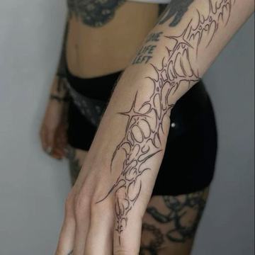 Neo tribal forearm tattoo with curved ornamental shapes