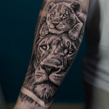 Lioness and cub tattoo on forearm